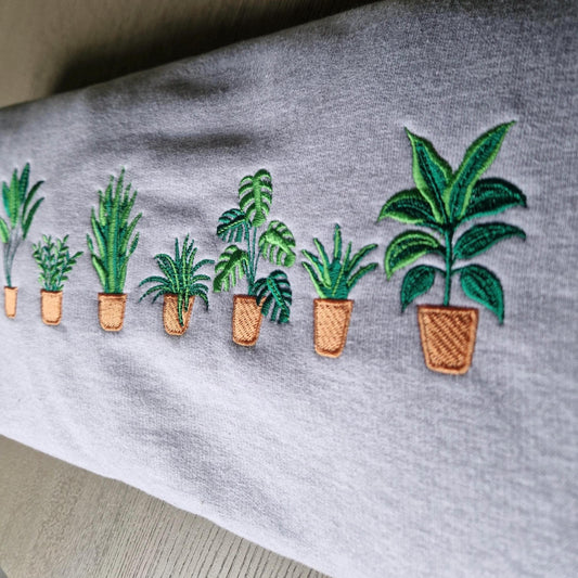 Embroidered plants on a gray fabric background